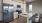 Spacious and well lit kitchen with wood flooring and stainless steel appliances