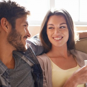Lifestyle at The Prescott at Park West Man and woman sitting on couch having coffee