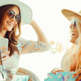 Lifestyle at The Prescott at Park West Two ladies with large hats laughing