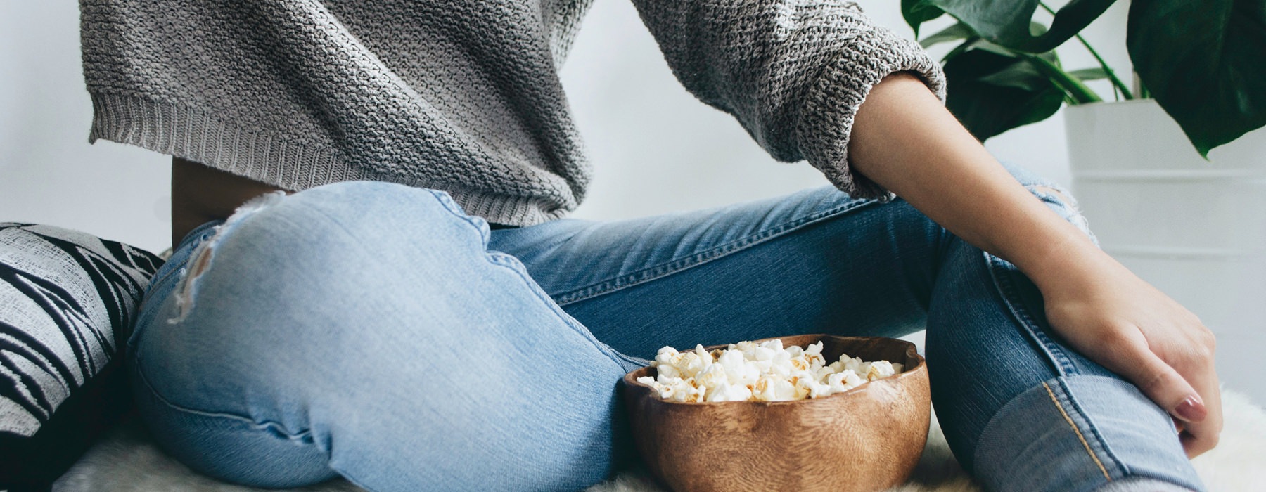 Woman sitting with a bowl of popcorn